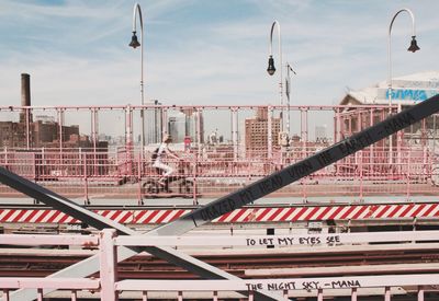 Woman cycling across railroad bridge