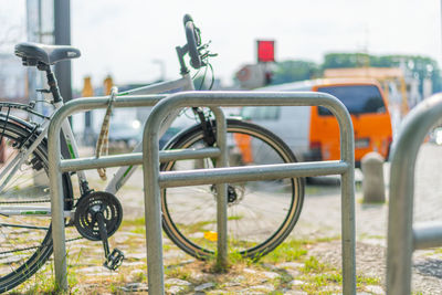 Close-up of bicycle parked on railing