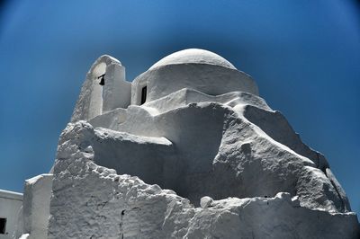 Low angle view of built structure against blue sky