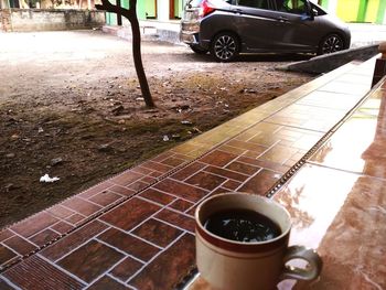 Coffee cup on wet street in rainy season