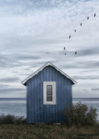 Seagull flying over sea against sky