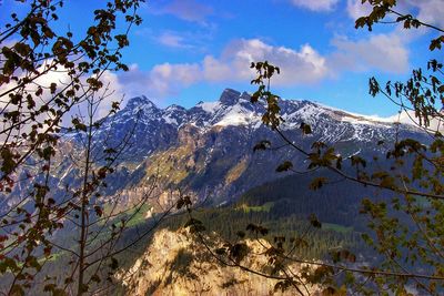 Scenic view of mountains against cloudy sky