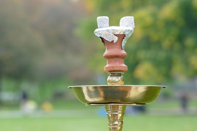 Close-up of cross against blurred background