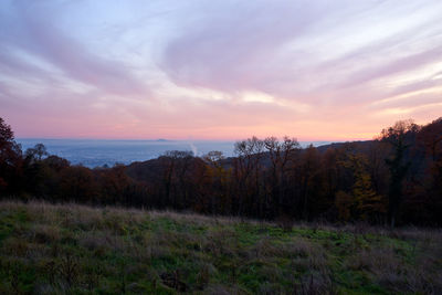 Scenic view of land against sky during sunset