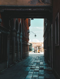 Empty alley amidst buildings in city