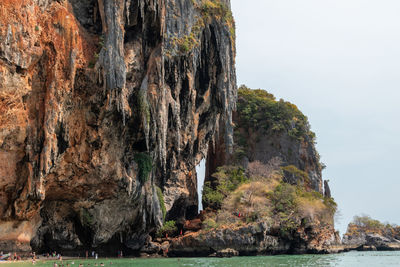 Rock formations by sea against sky