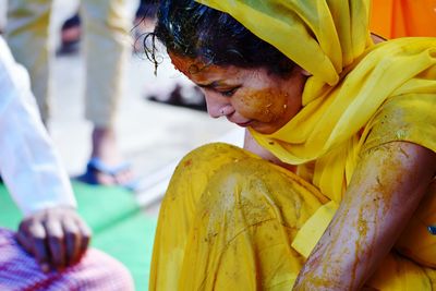 Close-up of young woman covered in turmeric paste