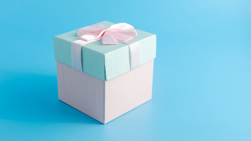 Close-up of gift box against blue background