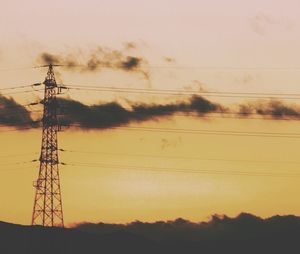 Low angle view of electricity pylon against sky