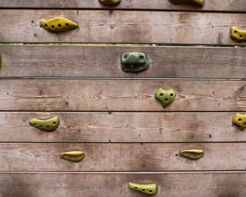 Close view of climbing holds on wooden board 