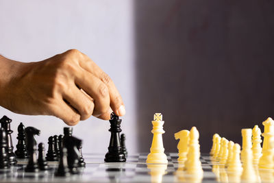 Selective focus on a human hand making move in chess game