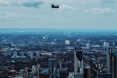 Aerial view of buildings in city against sky