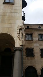 Low angle view of statue against building