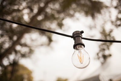 Low angle view of light bulb against sky