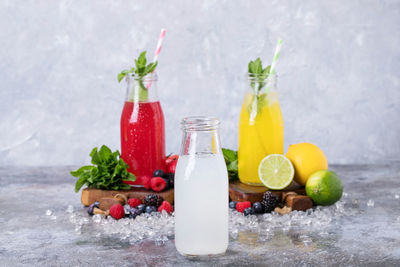 Fruits juices in glass jar on table