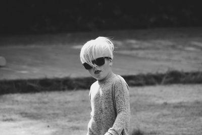 Portrait of boy wearing sunglasses standing on land