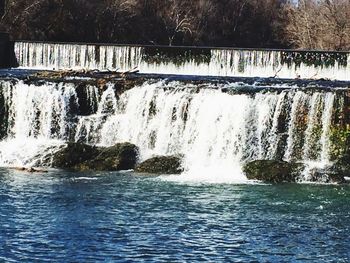 Scenic view of waterfall in river