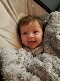 Portrait of cute baby lying on bed