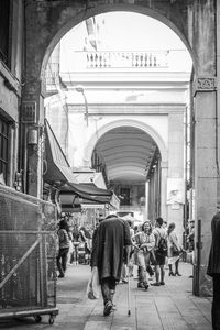 Rear view of people walking on building