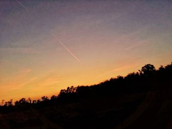 Low angle view of silhouette trees against sky during sunset