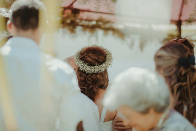 Rear view of people against blurred background