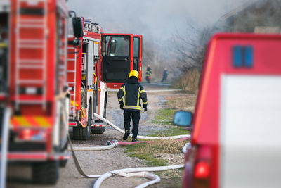 Rear view of firefighter in forest