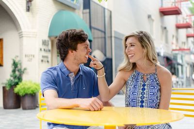 Playful young couple smiling in city