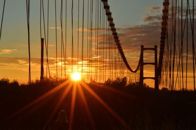 Sun shining through bridge