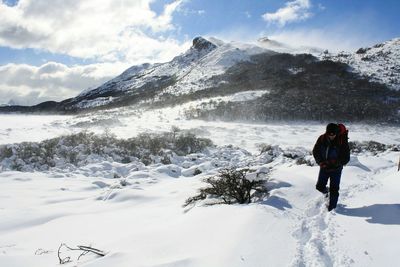 Tourists on snow covered mountain