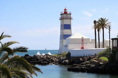 View of lighthouse in calm blue sea