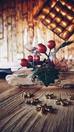 Close-up of christmas decorations on wooden table at home