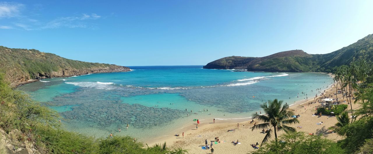 sea, beach, water, horizon over water, shore, sand, scenics, beauty in nature, tranquil scene, tranquility, vacations, blue, coastline, nature, high angle view, incidental people, sky, idyllic, mountain, tourism