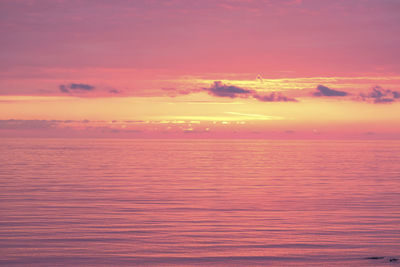 Scenic view of sea against romantic sky at sunset