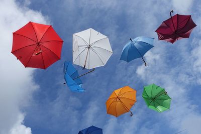 Low angle view of umbrellas against sky