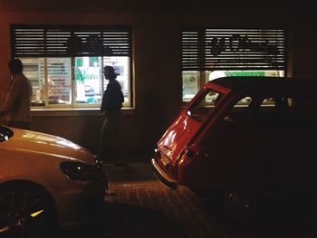 Rear view of woman standing in car
