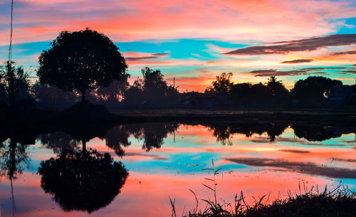 Scenic view of lake against sky during sunset
