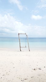 Lifeguard chair on beach against sky and beach. 