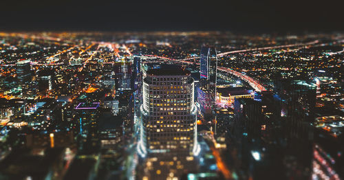 High angle view of city lit up at night