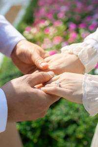 Couple holding hands on wedding day.