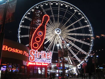 Low angle view of ferris wheel at night