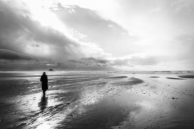 France, bretagne, finistere, crozon peninsula, woman walking on the beach