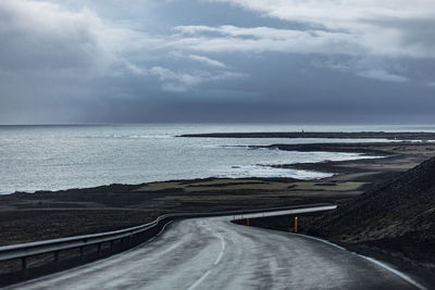 Road by sea against sky