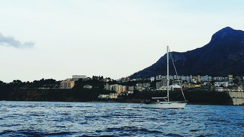 Boats in river with buildings in background