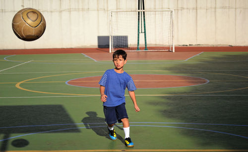 Full length of boy playing soccer