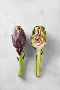 Close-up of green chili peppers on white background