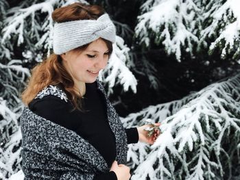 Young woman wearing hat in snow