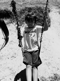 High angle portrait of boy enjoying swing