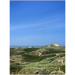 Scenic view of mountains against blue sky