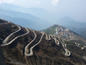 Winding roads on mountain during foggy weather