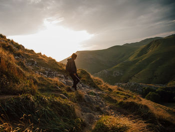 Man standing on mountain against sky